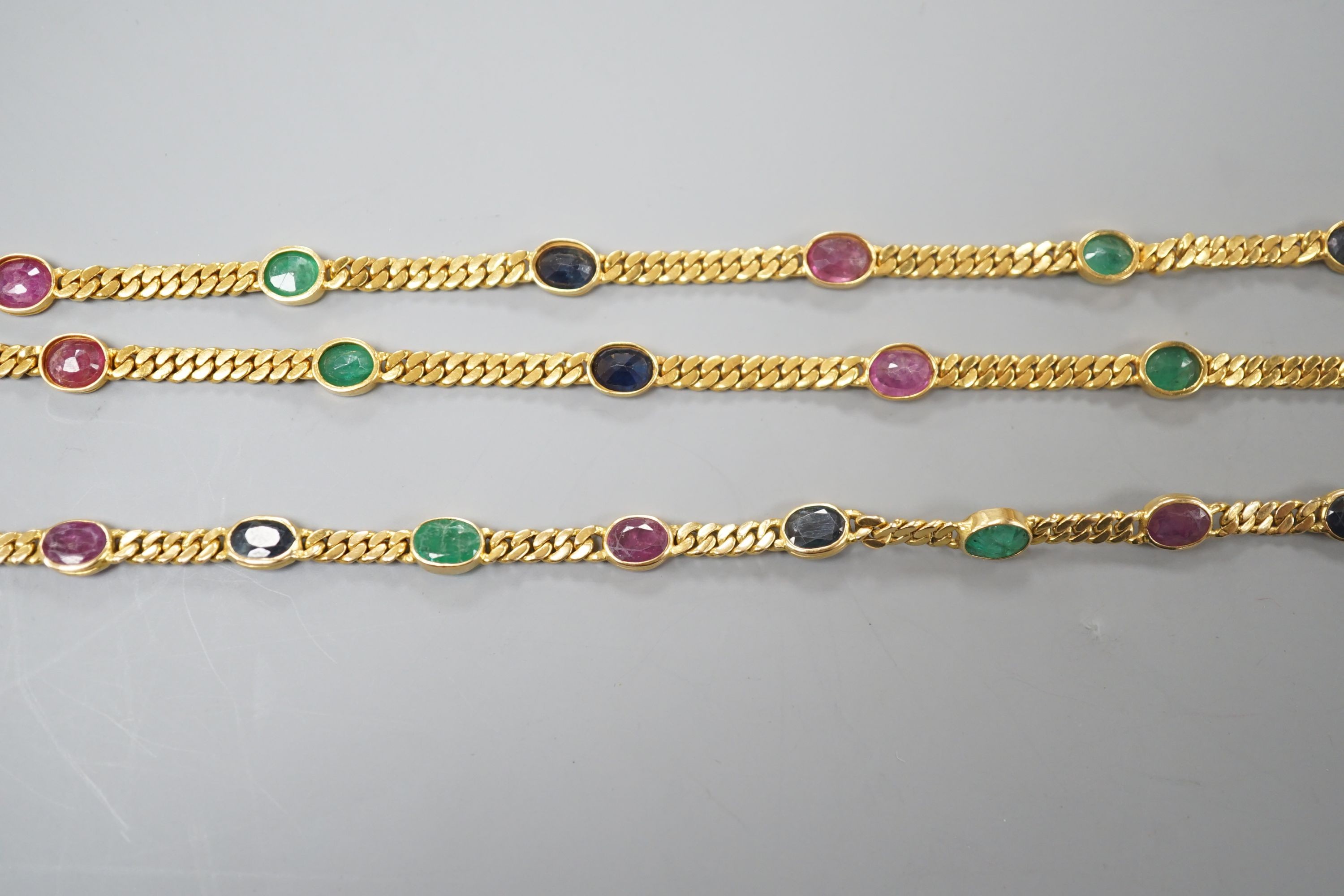 A modern Thai yellow metal and oval multi gem set necklace, 68cm and a similar bracelet, stamped 585, 17.5cm, gross weight 35.4 grams.